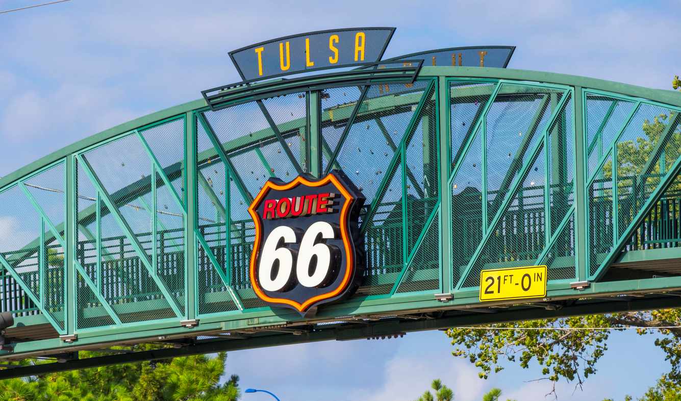 The sign of the Route 66 on a green bridge in Tulsa, OK