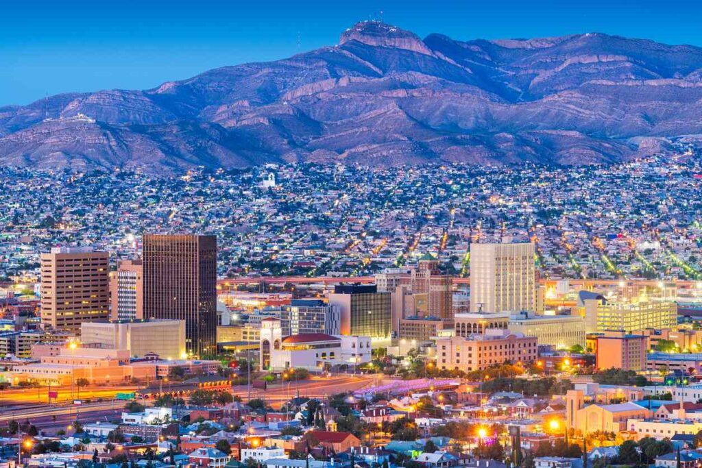 Downtown El Paso skyline with city buildings illuminated at dusk.