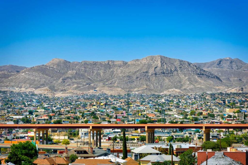 View of El Paso, Texas, with residential neighborhoods, an elevated highway, and the Franklin Mountains in the background